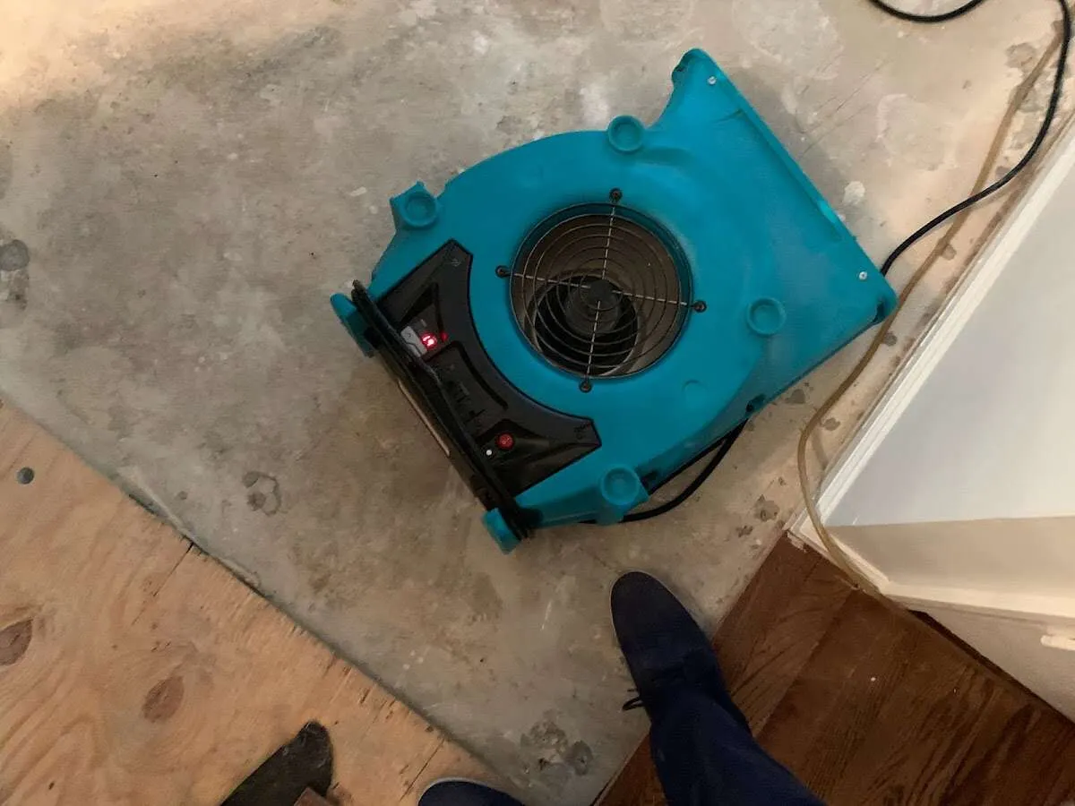 Air mover drying subfloor during Commercial Water Damage Restoration in Four Corners